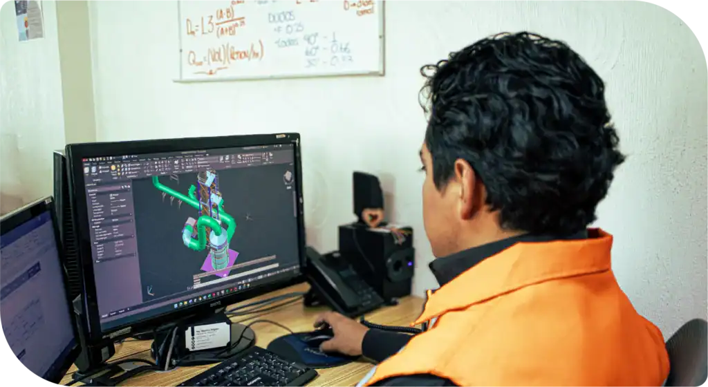 Ingeniero de MCAT modelando en CAD 3D un sistema de ventilación industrial con ductos y equipo de proceso